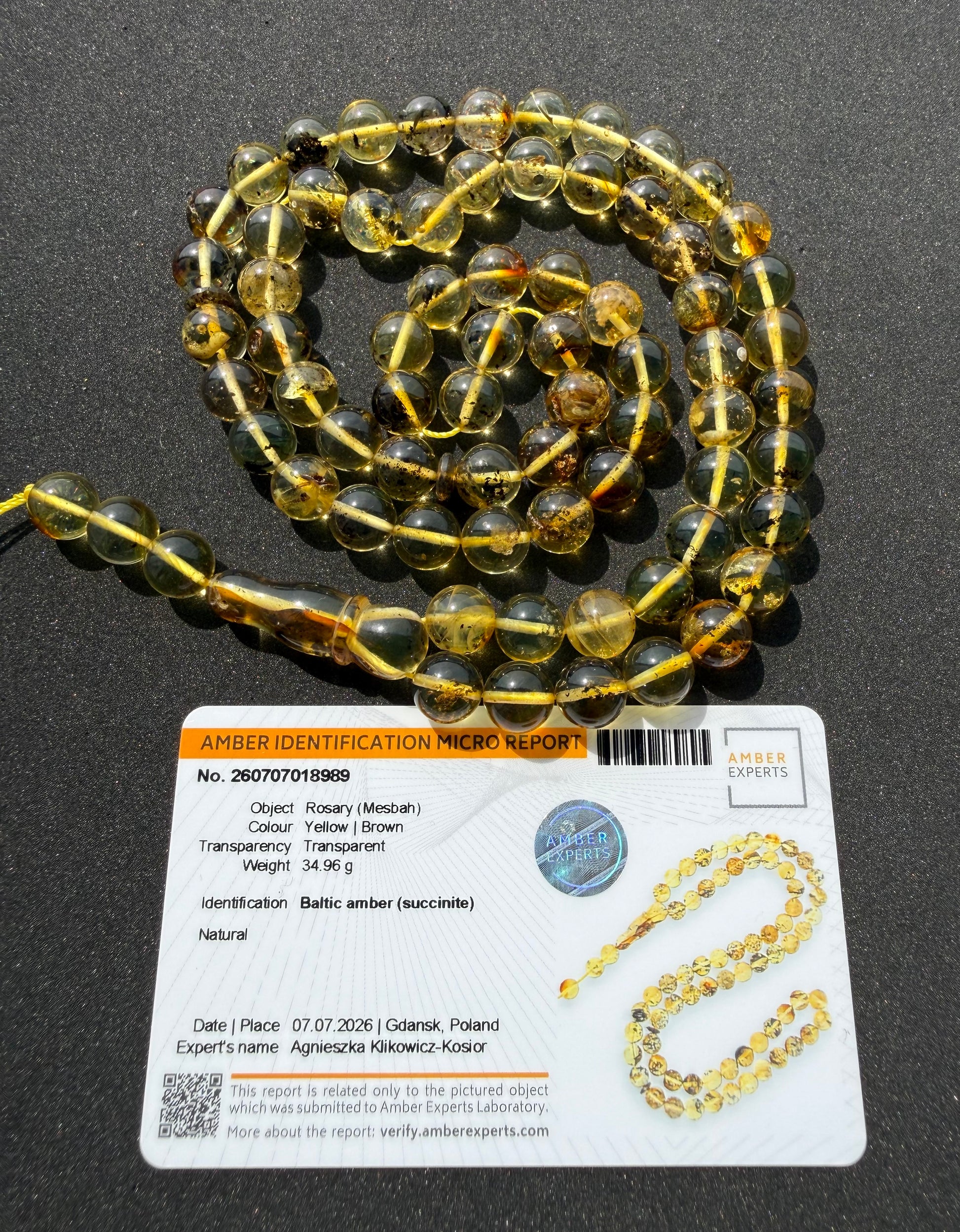 Genuine Baltic amber prayer beads with natural inclusions and transparent finish.