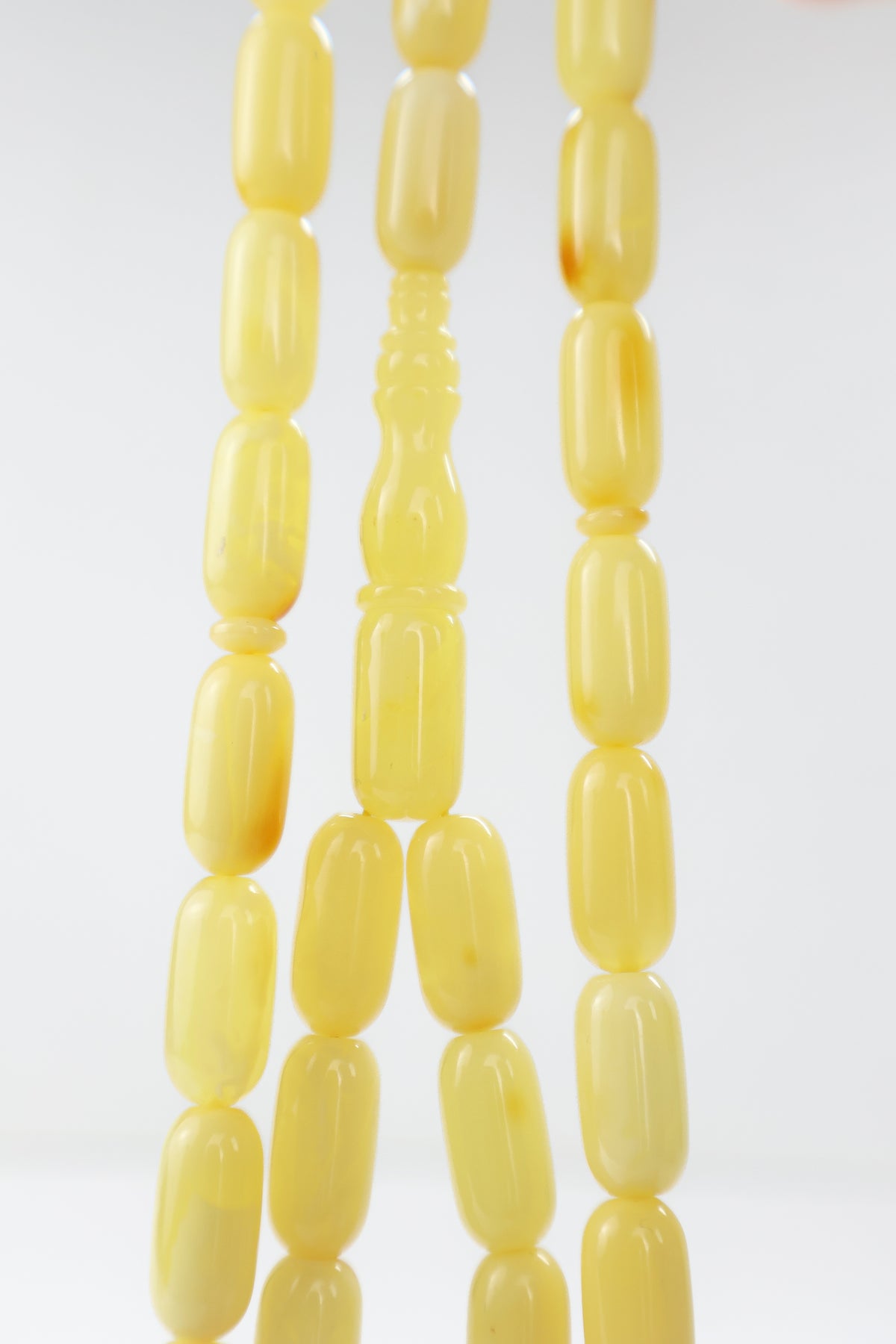 Laboratory certified natural Baltic amber rosary display with official micro report card from Tetibel Amber Jewels.